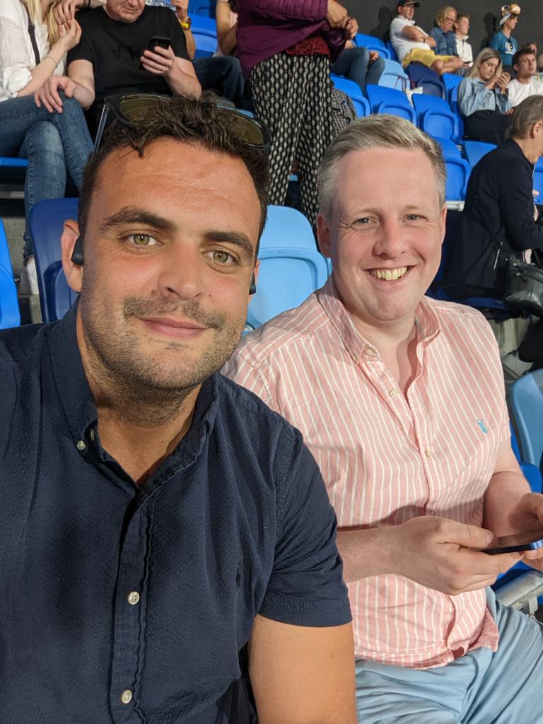 Dan, 36, with a friend at a sporting event.