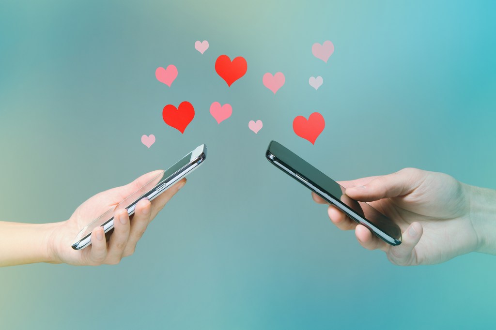 A graphic symbolizing love found on dating apps, using smartphones and hearts. 