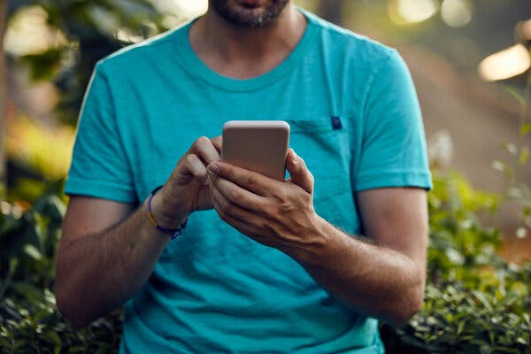 A man types on a smartphone.